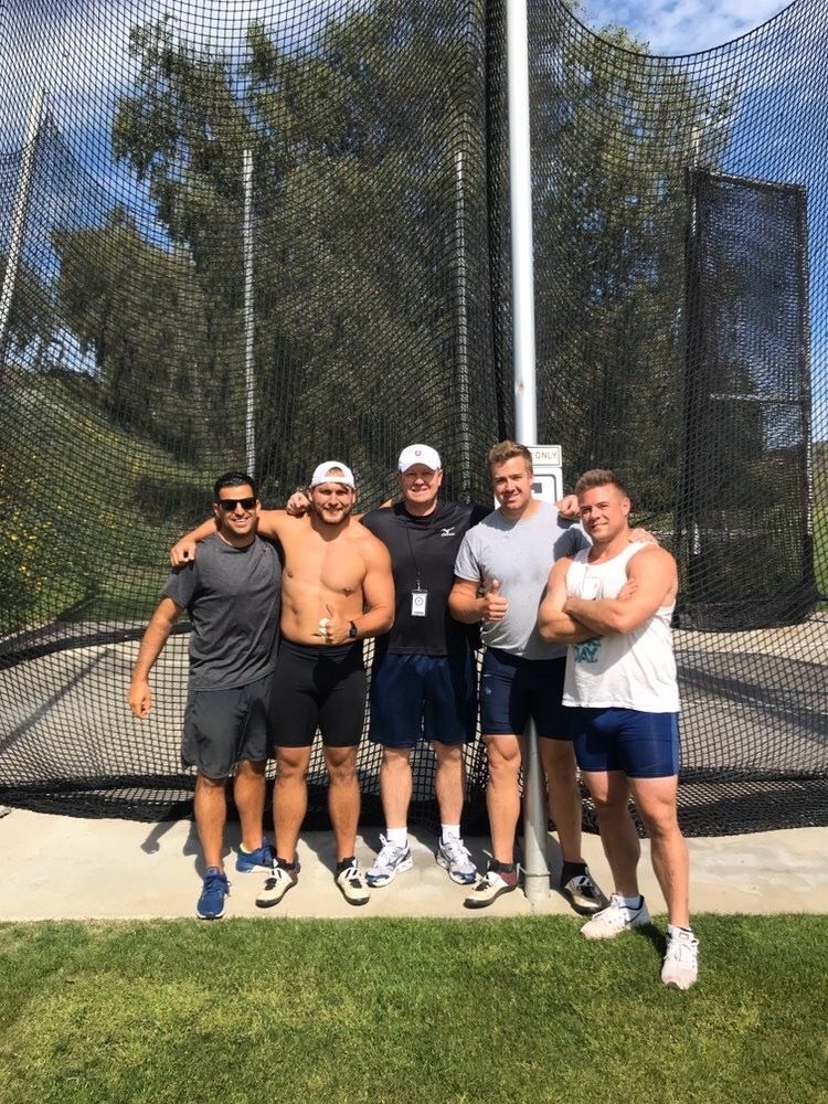 Mike with the U.S. throws coach, his training partner, and two Slovak Olympians in front of a hammer cage