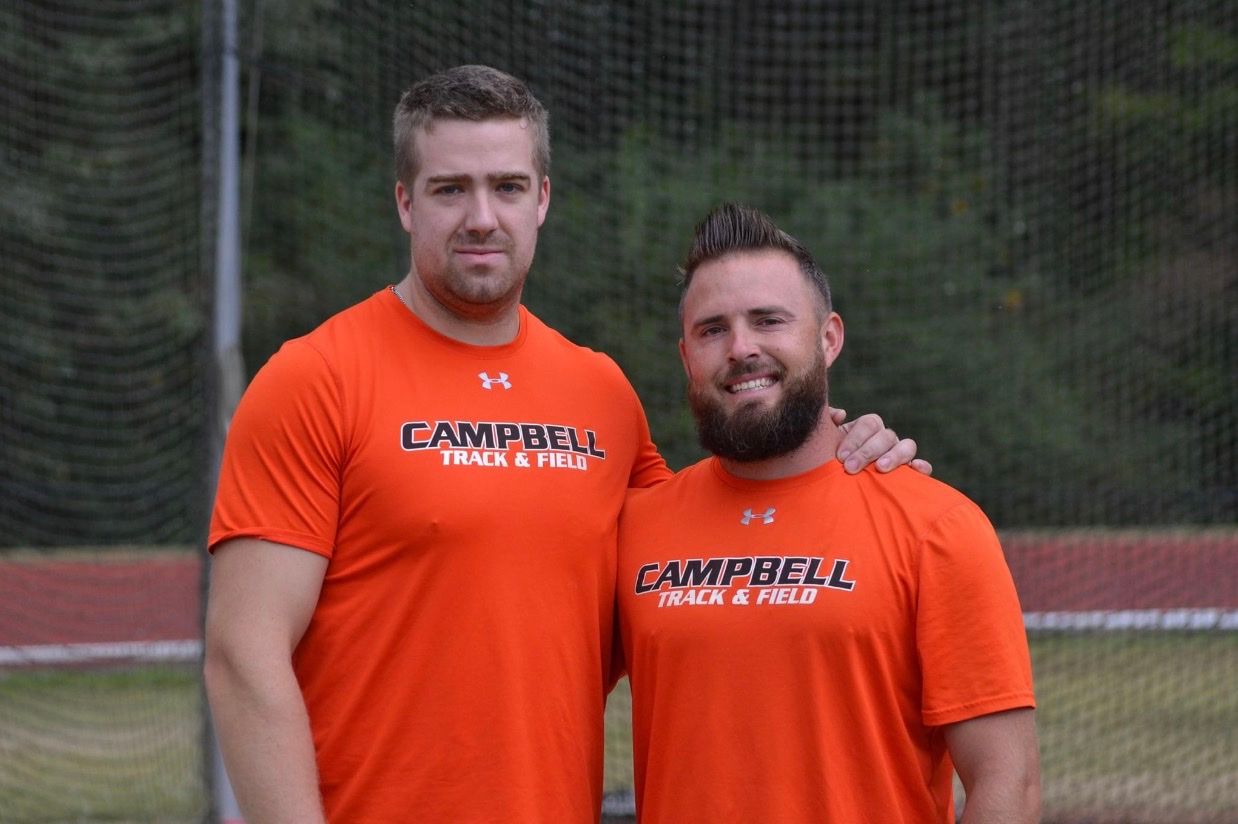Mike and Jeffrey Klaves in Campbell Track & Field shirts in front of a hammer cage